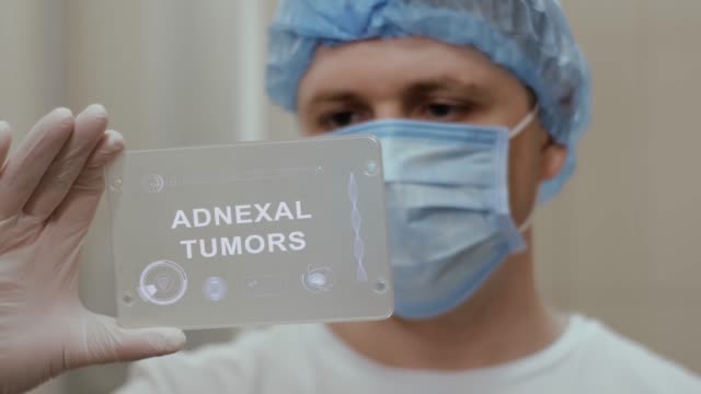 Doctor uses tablet with text Adnexal Tumors