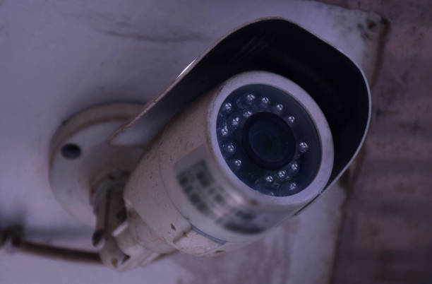 istock Side angle shot of an old surveillance or CCTV camera fitted in a wall 1235667924