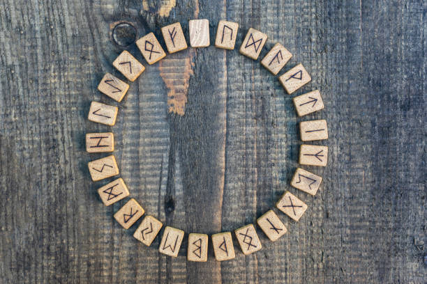 Scandinavian wooden runes on an old wooden table. Elder Futhark. Scandinavian wooden runes on an old wooden table. Elder Futhark. runes stock pictures, royalty-free photos & images
