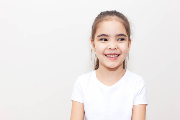 istock Curious Smiling Small Girl 1235748907