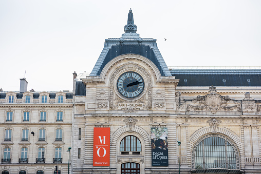 Musee d'Orsay or Orsay museum building facade with clock in a cloudy day in Paris, France