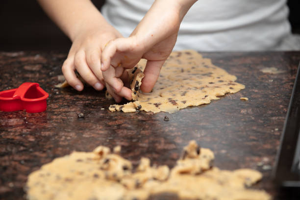 istock Close-up child`s hands preparing cookies 1235769855