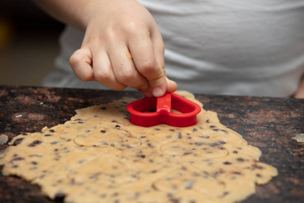 Close-up child`s hands preparing cookies