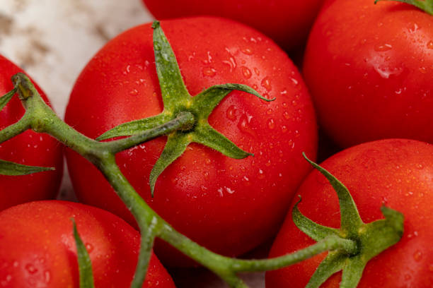 istock Organic red tomatoes isolated on a white background. 1235771899