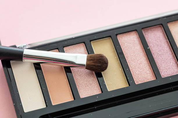 istock Eyeshadow pallete kit against pink background, copy space 1235804731