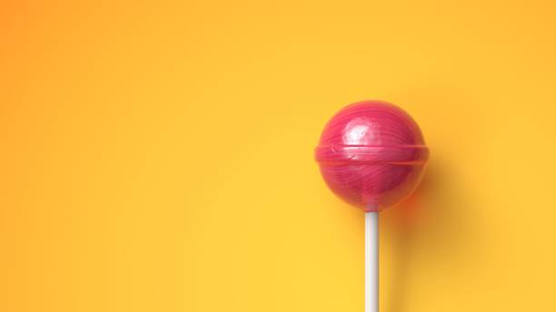istock Sweet lollipop on bright yellow background with copy space 1235806798