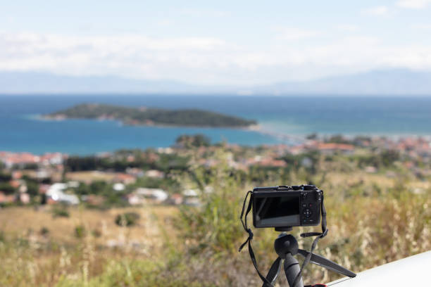 istock Digital camera on camera tripod taking a photo of panoramic  landscape 1235838760
