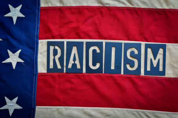 The word Racism spelled over the American Flag