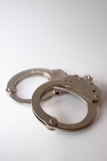 istock steel metal Handcuffs on  white background isolate 1235844456