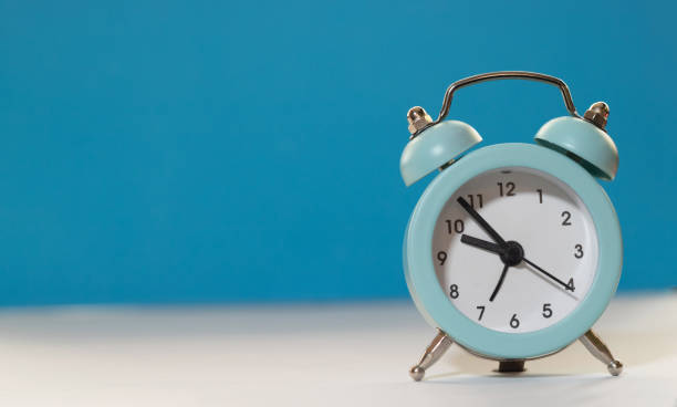 istock Alarm clock on a blue background Place for text 1235849645