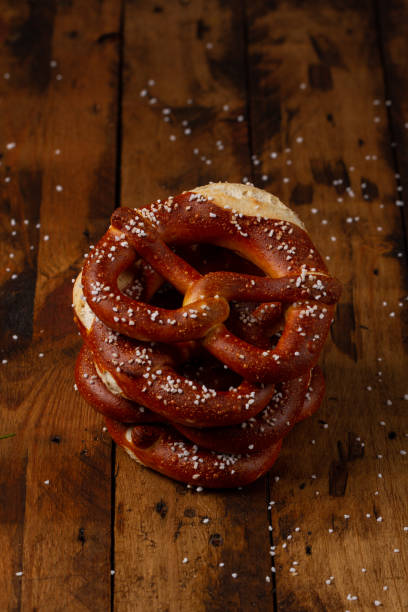 istock German Brezel pretzel with salt on wooden background 1235861623