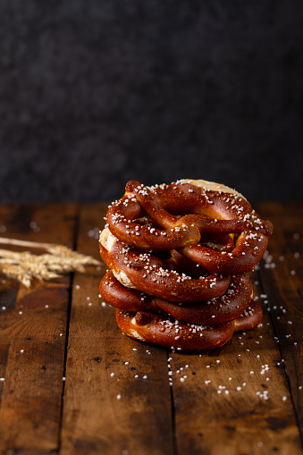 German Brezel pretzel with salt on wooden background
