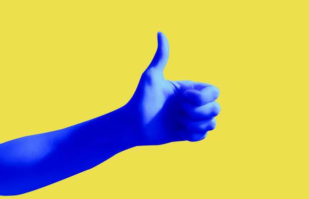 istock Blue hand gesture on yellow background poster. Thumb up. Like social web. 1235873048