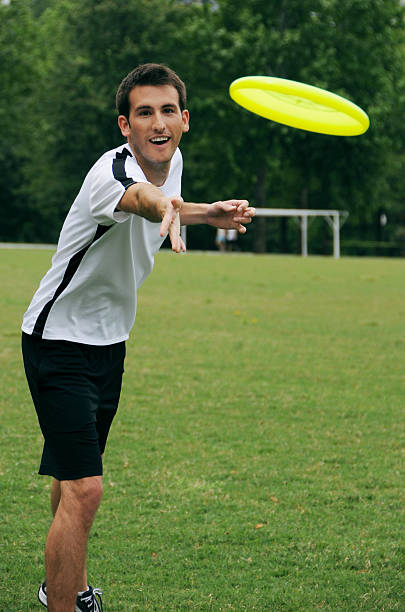 istock Young man throwing Frisbee in park 123589633