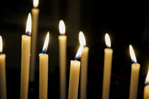 istock Some lit candles in a church 1235896507