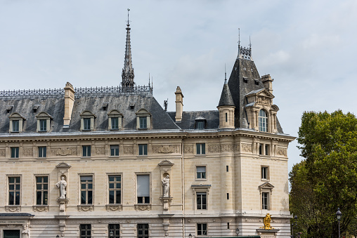 Historic La Conciergerie Buildings and tower of Notre Dame Cathedral in the Ile de la Cite in central Paris, France.
