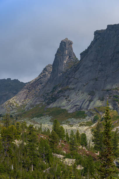istock rocky ridge under blue sky in mountain valley, journey of climbers on sheer cliffs 1235906473