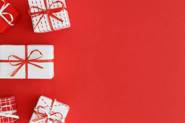 istock Red and white christmas gifts on a red background. Flat lay with blank copy space. 1235907515