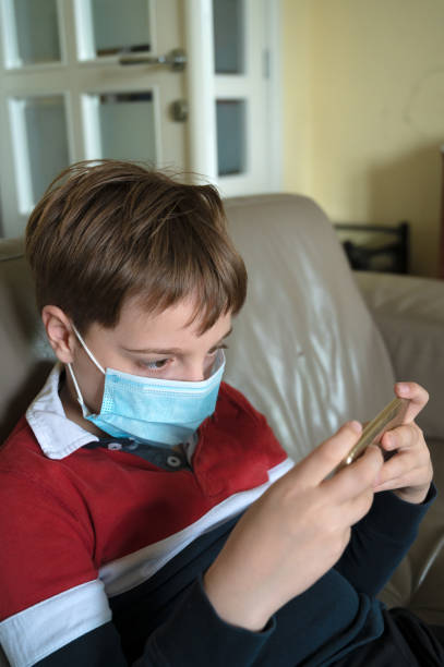istock Boy with mask at home 1235935665
