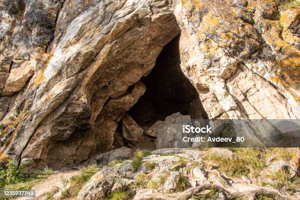 Small Cave Or Grotto In Mountain Cliff Mountaineering And Caving In Rocks Stock Photo - Download Image Now