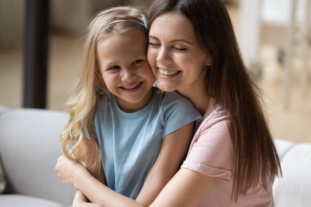 istock Happy mom and small daughter hugging at home 1235944732