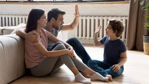 istock Smiling young parents relax at home with small son 1235945047