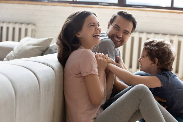 istock Excited little boy playing with young parents on home weekend 1235945050