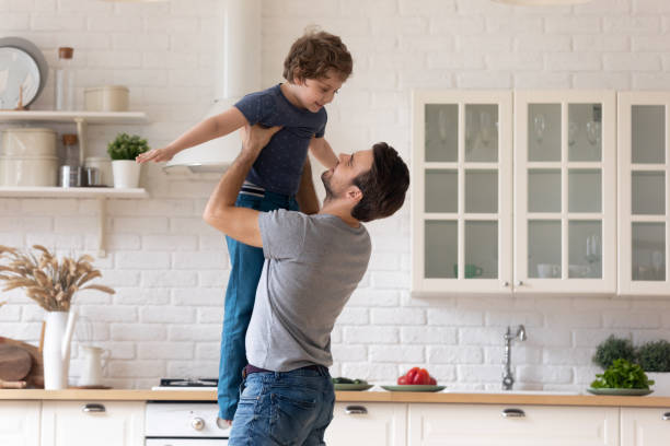 istock Loving young dad playing with small son at home 1235945065