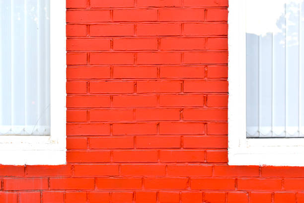 Pink brick building wall with windows, full frame