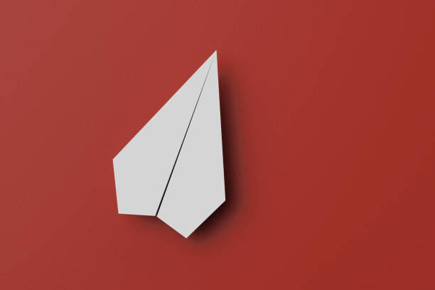istock paper airplane on a red background, 3D rendering 1235948722