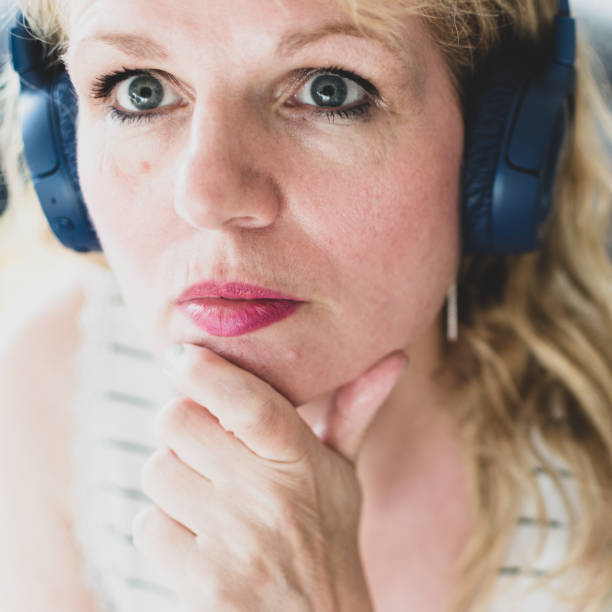 istock mature woman with wireless bluetooth headphones 1235959734