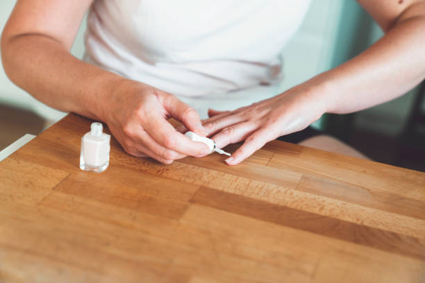 istock Unrecognizable woman applying nail polish 1235984988