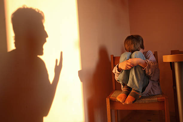 Aggressive parent Aggressive parent. Father's shadow yelling on a small child. Child is in distress. child abuse photos stock pictures, royalty-free photos & images