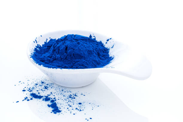 istock Blue spirulina powder in white spoon isolated on white background. Phycocyanin extract. Natural superfood, vegan, healthy dietary supplement. 1236004521