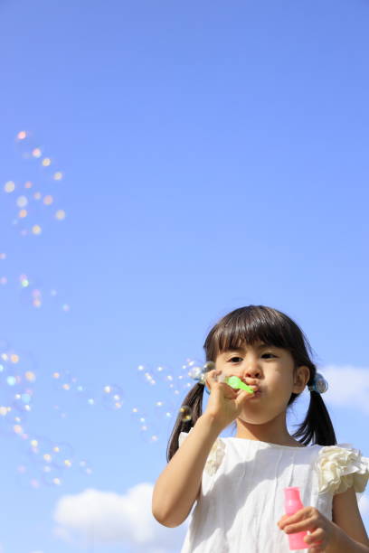 istock Japanese girl playing with bubble under the blue sky (5 years old) 1236025217