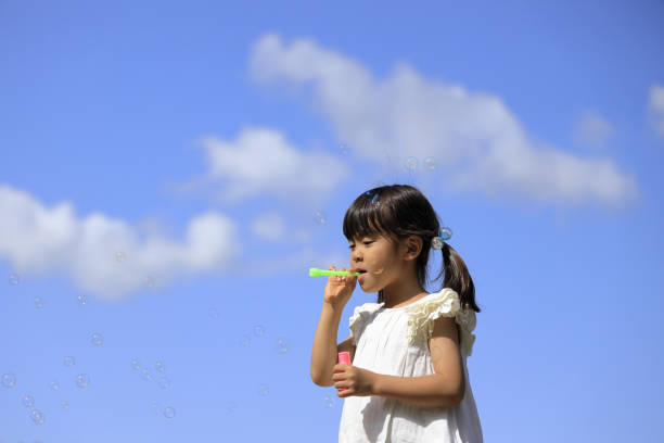 istock Japanese girl playing with bubble under the blue sky (5 years old) 1236026785