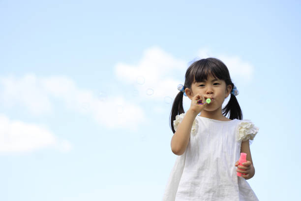 istock Japanese girl playing with bubble under the blue sky (5 years old) 1236027317