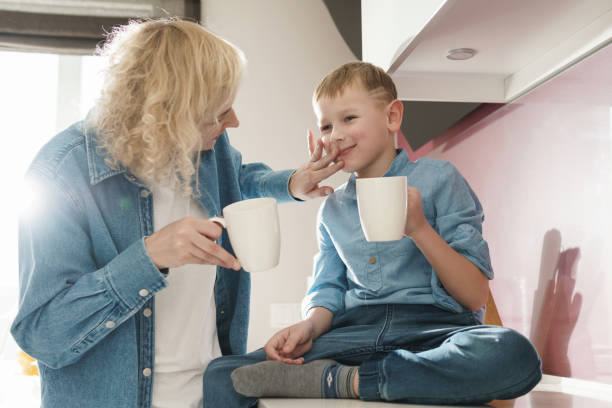 istock Mother and her cute son drinking tea in the kitchen 1236055861
