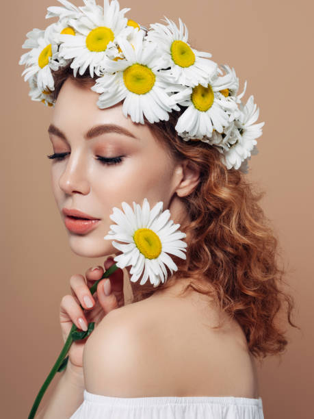 istock Girl with a chamomile wreath on her head 1236055863
