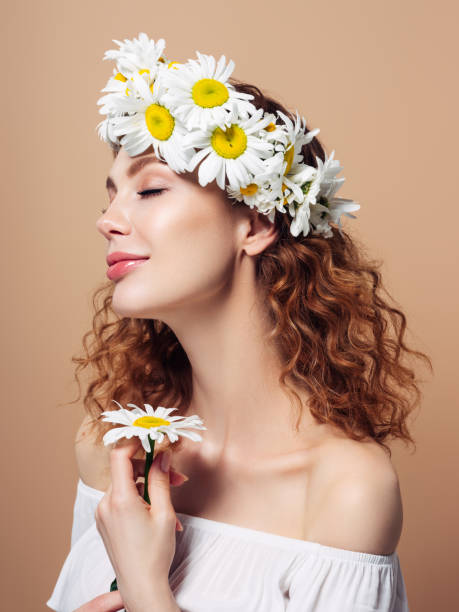 istock Girl with a chamomile wreath on her head 1236056390
