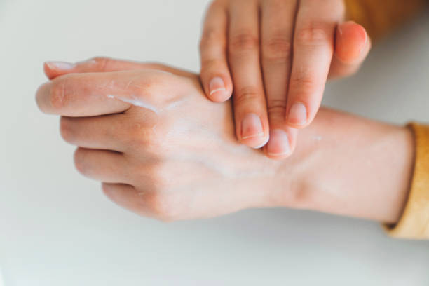 istock Woman hands applying hand cream 1236057947