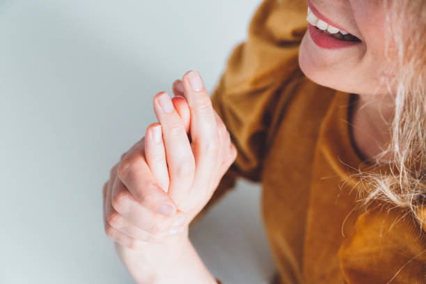 happy asian woman shows her natural nails without nail polish