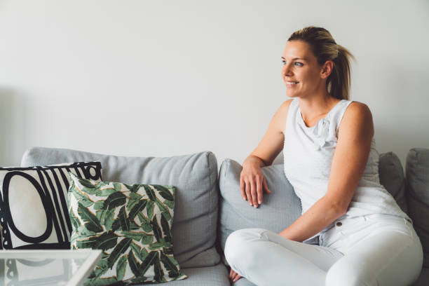 istock Blonde caucasian woman relaxing on the couch 1236059632