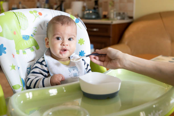 istock a little baby eating at home 1236060262