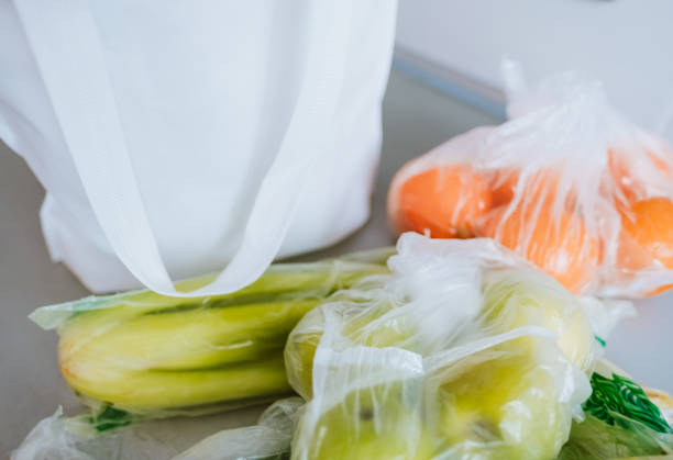 istock White eco bag with spread out fruits and vegetables on a table. 1236110763