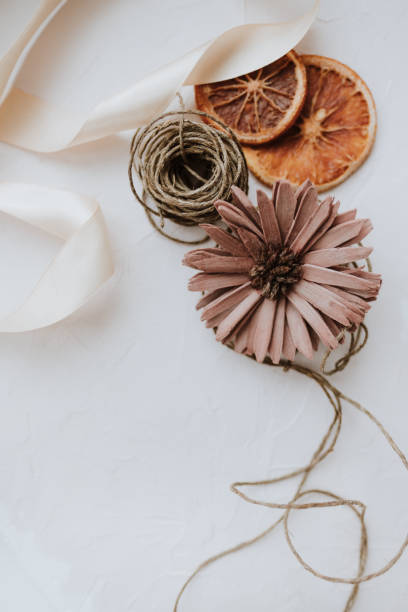 istock Dried flower and festive ribbon on white background. 1236112310