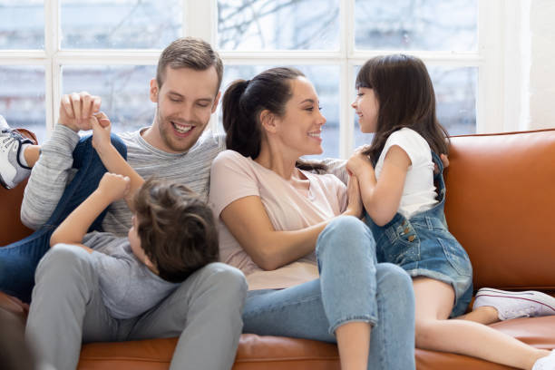 istock Happy parents playing with little kids relaxing on couch 1236117005