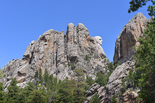 Less known, South side of the famous Mount Rushmore in South Dakota, where sculpture of four presidents had been carved. President George Washington’s face visible.