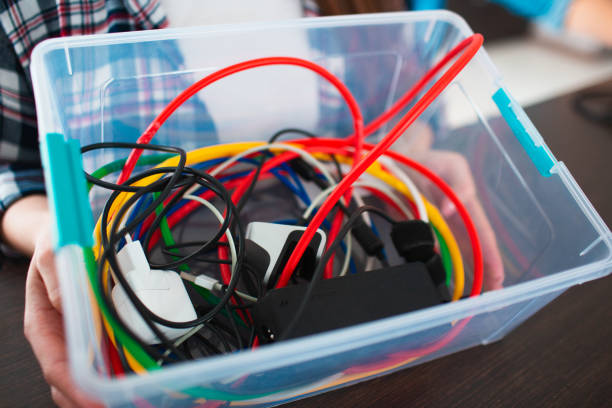 istock close-up Environmental Protection. Family is sorting old household electrical devices. Glass, light bulbs, iron, rubber, metal, batteries and wires should be recycled. Responsibly protect nature 1236162393