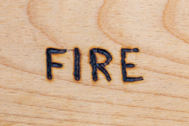 istock the word fire handwritten on wooden surface with electrical woodburner 1236182131